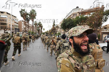 Khaled Brigade, a part of Hay'at Tahrir al-Sham (HTS), hold a military parade, in Damascus