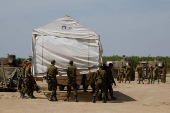 Israeli soldiers move a tent, near the Israel-Gaza border