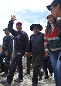 Bolivian President Luis Arce Catacora inspects the Inca Llojeta area, where intense rains and illegal earth movements caused landslides that flooded several homes, in La Paz