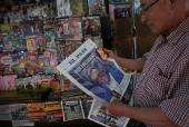 A kiosk displays newspaper headlines after the results of yesterday's elections, in Montevideo