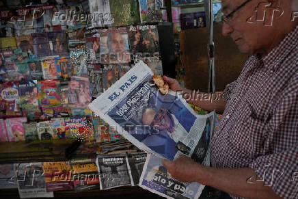 A kiosk displays newspaper headlines after the results of yesterday's elections, in Montevideo