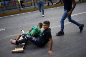 Government supporters participate in a traditional street race with wooden makeshift carts called 