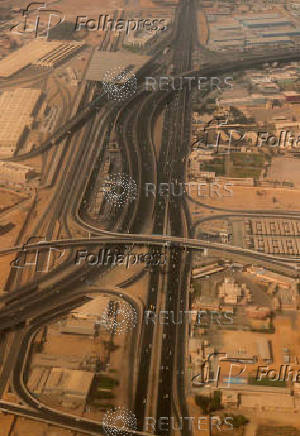 An aerial view shows bridges and new roads with Cairo's traffic, and the Adly Mansour Transportation Hub and interchange station