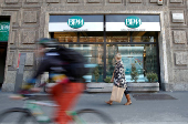 FILE PHOTO: A woman walks in front of the Banca Popolare di Milano (BPM) bank in downtown Milan