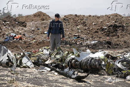 FILE PHOTO: American civil aviation and Boeing investigators search through the debris at the scene of the Ethiopian Airlines Flight ET 302 plane crash, near the town of Bishoftu, southeast of Addis Ababa