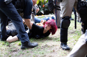 Law enforcement hold a pro-Palestinian protester at the University of Texas