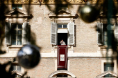 Pope Francis leads the Angelus prayer from his window, at the Vatican