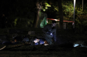 Israeli emergency services work at the scene of a missile strike, in Jaffa, south of Tel Aviv