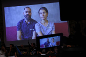 The family of Hersh Goldberg-Polin appears on a screen via video link during a news conference in Tel Aviv