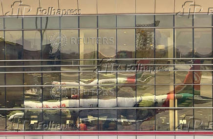 FILE PHOTO: Reflection shows Kenya Airways planes parked at the Jomo Kenyatta International Airport near Nairobi