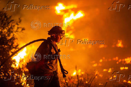 Firefighters and aircraft battle the Hughes Fire near Santa Clarita