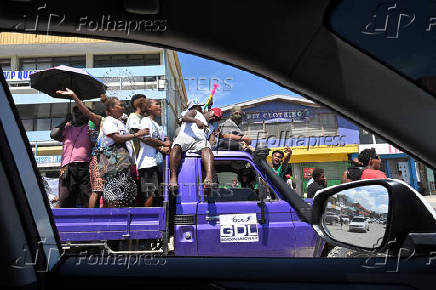 Supporters of former prime minister Gordon Darcy Lilo cheer and wave ahead of the election in the capital Honiara