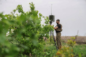 Ukrainian serviceman sets up an antenna before using a reconnaissance UAV in a front line in Donetsk region