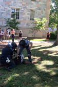 A man is teased while being detained by law enforcement officers at Emory University campus in Atlanta