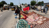 People take refuge along an expressway after relief camps reached maximum capacity in Maiduguri