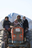 Displaced people who fled from Aleppo countryside, ride on a vehicle in Tabqa