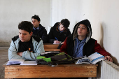 Students in a classroom after authorities announced the reopening of schools, in Damascus