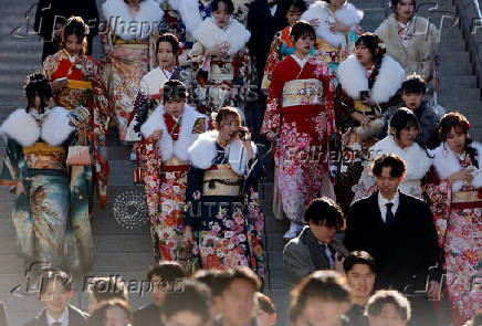 Youth including Kimono-clad women leave the venue after their Coming of Age Day celebration ceremony in Yokohama