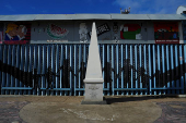 A Mexico-U.S. boundary marker stands next to the primary border fence at Playas Tijuana