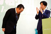 Incoming Defence Minister Wellington Koo bows next to Taiwan President-elect Lai Ching-te during a press conference, in Taipei