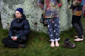 Revellers attend winter solstice celebrations at Stonehenge stone circle near Amesbury