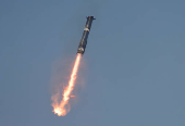 The Super Heavy booster returns to its launch pad after the SpaceX Starship continued to space after it was launched on its eighth test at the company's Boca Chica launch pad in Brownsville