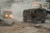 Israeli military vehicles drive in Tulkarm