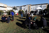 Members of the media gather outside the Gemelli Hospital where Pope Francis is admitted to continue treatment for ongoing bronchitis, in Rome