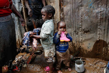 Residents recover their belongings after the Nairobi river burst its banks in Mathare Valley settlement in Nairobi