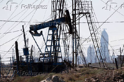 FILE PHOTO: A nodding donkey pumps oil in an oil field in the settlement of Balaxani