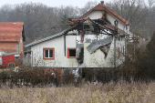 Emergency personnel work at a damaged nursing home that caught fire, outside Belgrade