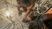 Palestinians work to rescue a child from under the rubble following an Israeli strike, amid the Israel-Hamas conflict, in Nuseirat in the central Gaza Strip