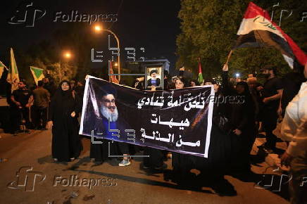 Supporters of Hezbollah Brigades protest against the killing of Nasrallah, in central Baghdad