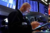 Traders work on the floor of the NYSE in New York