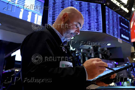 Traders work on the floor of the NYSE in New York