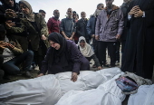 Palestinians mourn their dead at Deir Al Balah hospital after Israeli airstrike in central Gaza