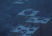 A window is illuminated in a residential building during power outages in Kyiv