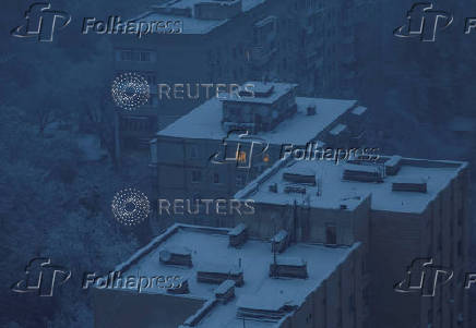 A window is illuminated in a residential building during power outages in Kyiv