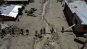 Members of Volunteer Search and Rescue Service (SAR) assist residents affected by floodings due to landslides caused by intense rains and illegal earth movements, in the Inca Llojeta area