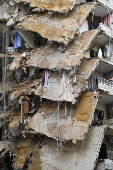 People check damaged buildings after Israeli military strikes on Beirut