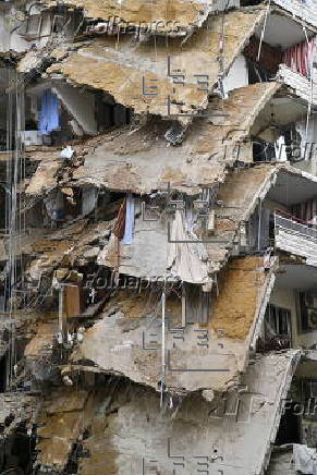 People check damaged buildings after Israeli military strikes on Beirut