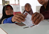 Voters cast their ballows in regional government elections in Indonesia