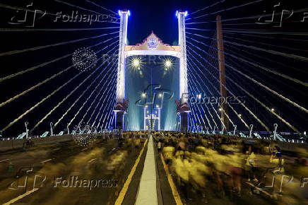 People attend a running event on the newly constructed cable-stayed, Rama X Bridge or 