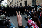 Youths take part in the occupation of a street in front of the building of the Sciences Po University in Paris