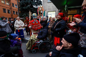 People dressed in traditional clothes sing carols for injured service members in Kyiv