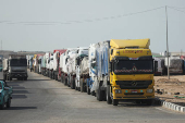 Aid trucks wait near the Rafah border crossing between Egypt and the Gaza Strip