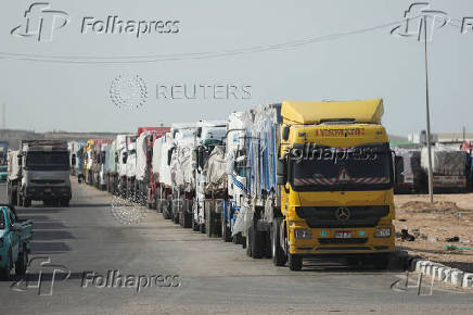 Aid trucks wait near the Rafah border crossing between Egypt and the Gaza Strip