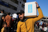 Palestinians receive aid following a ceasefire between Israel and Hamas, in Khan Younis in the southern Gaza Strip