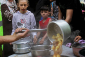 Volunteers deliver food to families, amid the ongoing conflict between Israel and the Palestinian Islamist group Hamas, in Jabalia