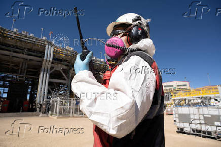 A worker uses a radio in the molybdenum warehouse at Anglo American's Quellaveco copper mine in Peru